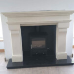 multi fuel stove in black inset with white marble surround