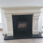multi fuel stove in black inset with white marble surround