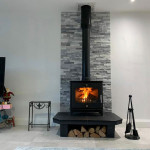 Modern Multi fuel stove with slate backing and log storage