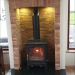 Multi fuel stove in brick surround